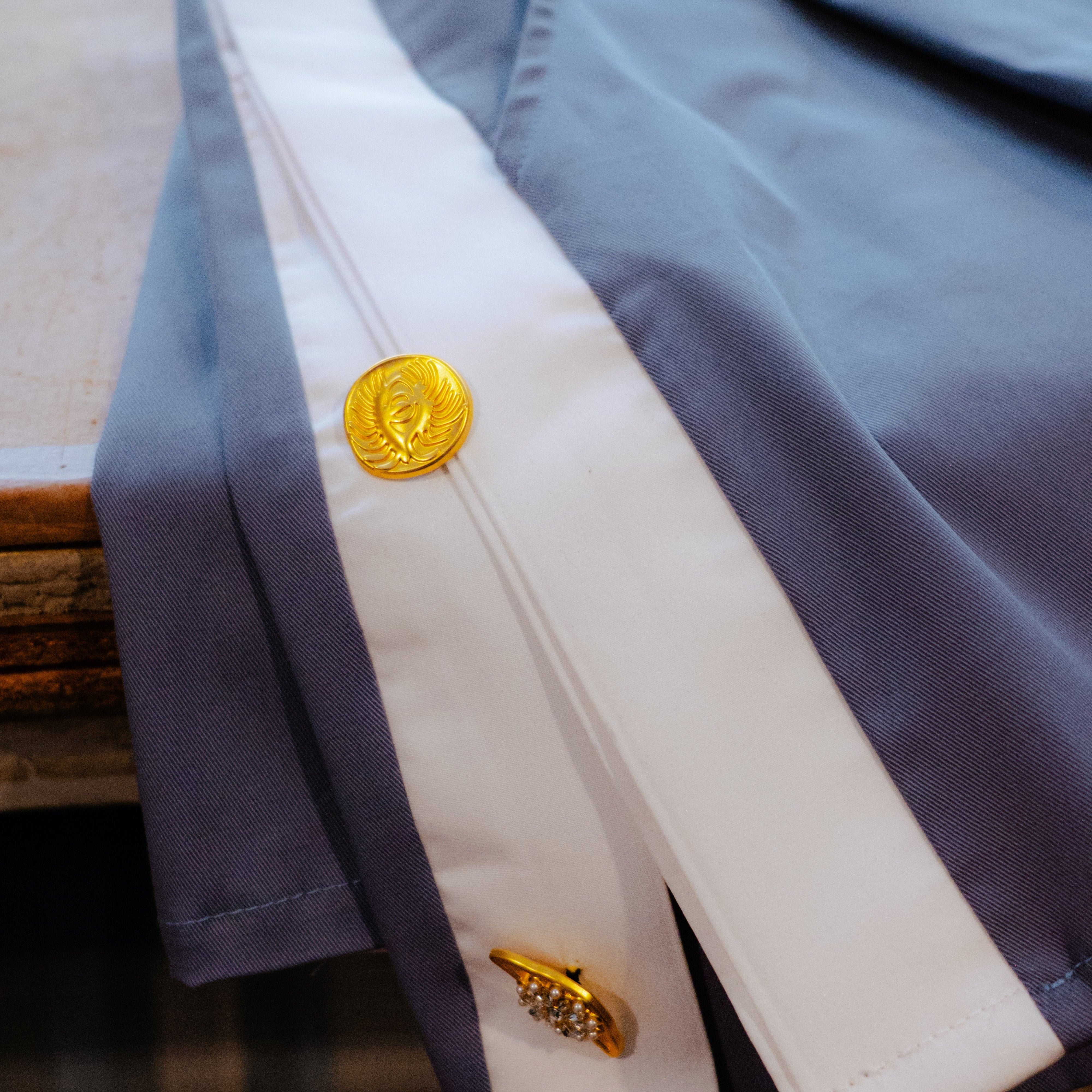 Close-up of a blue shorts with gold buttons