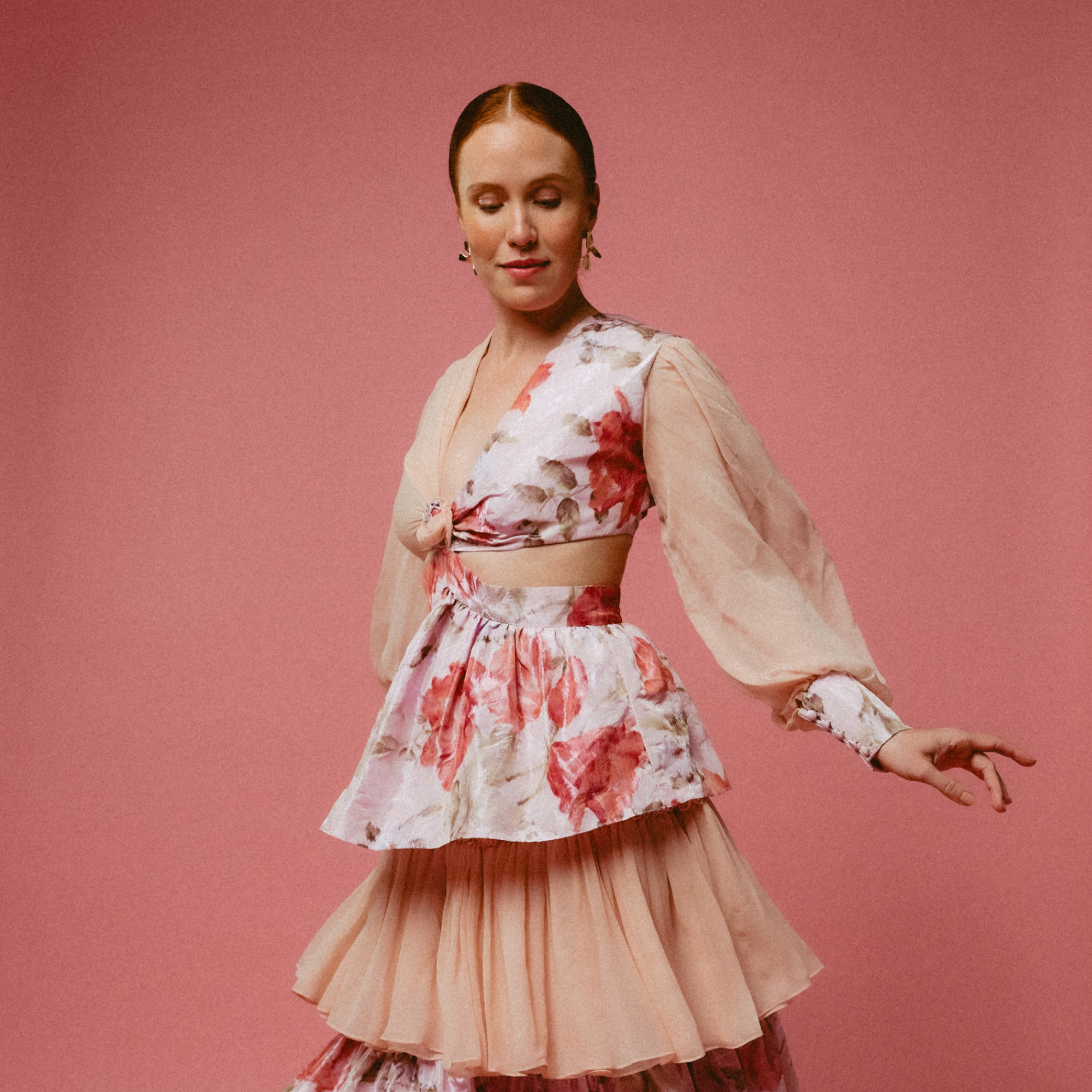 Woman wearing a floral dress with a pink background