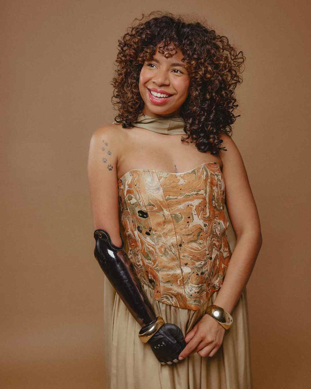 Kayla wearing a marbled corset against a brown background